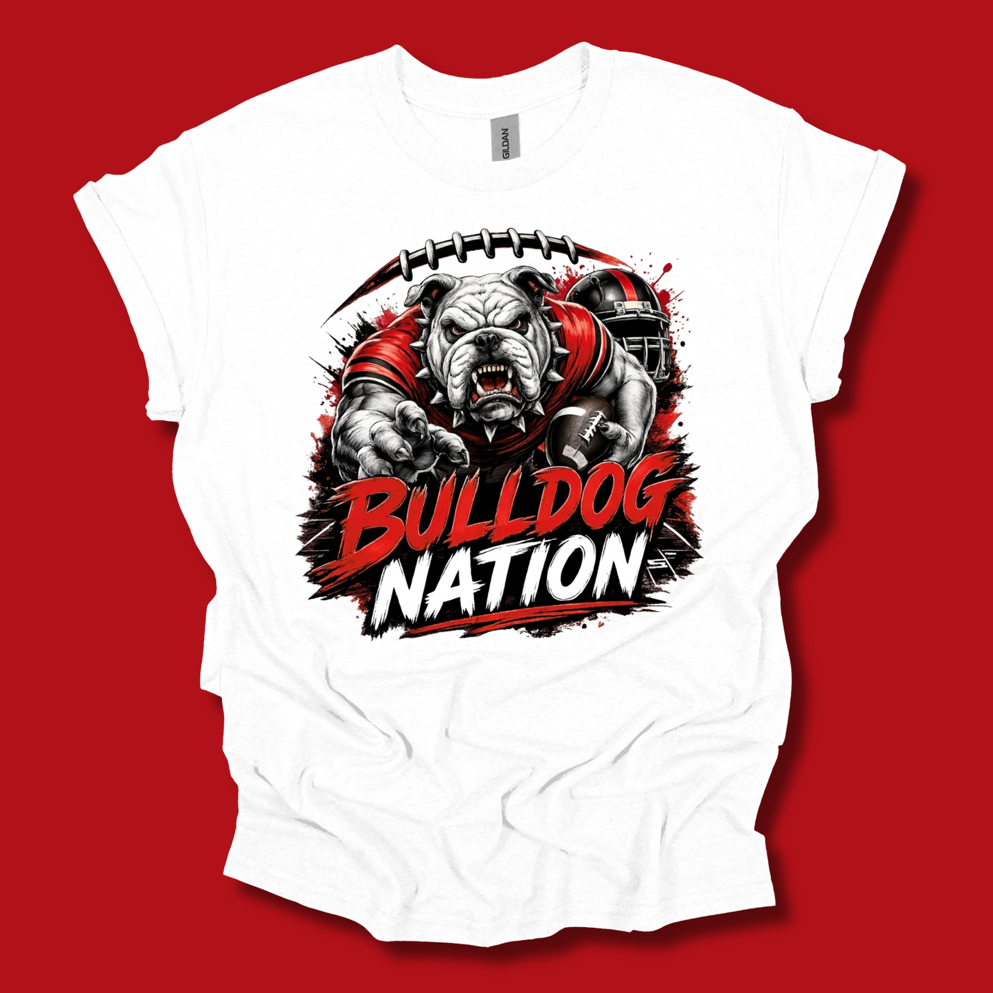 A white short-sleeve t-shirt with a graphic of a bulldog football player and the text 'BULLDOG NATION' in red and white, displayed against a solid red background.