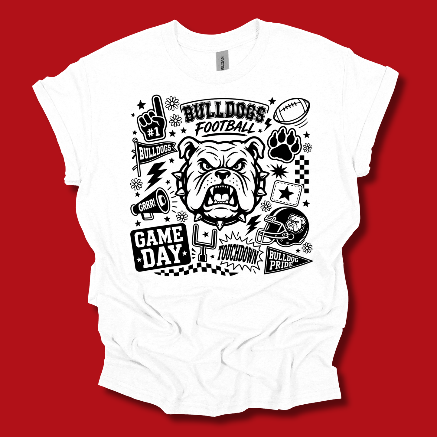 A white short-sleeve t-shirt with a black graphic print featuring a bulldog mascot, football elements, and 'BULLDOGS FOOTBALL' text, displayed against a solid red background.