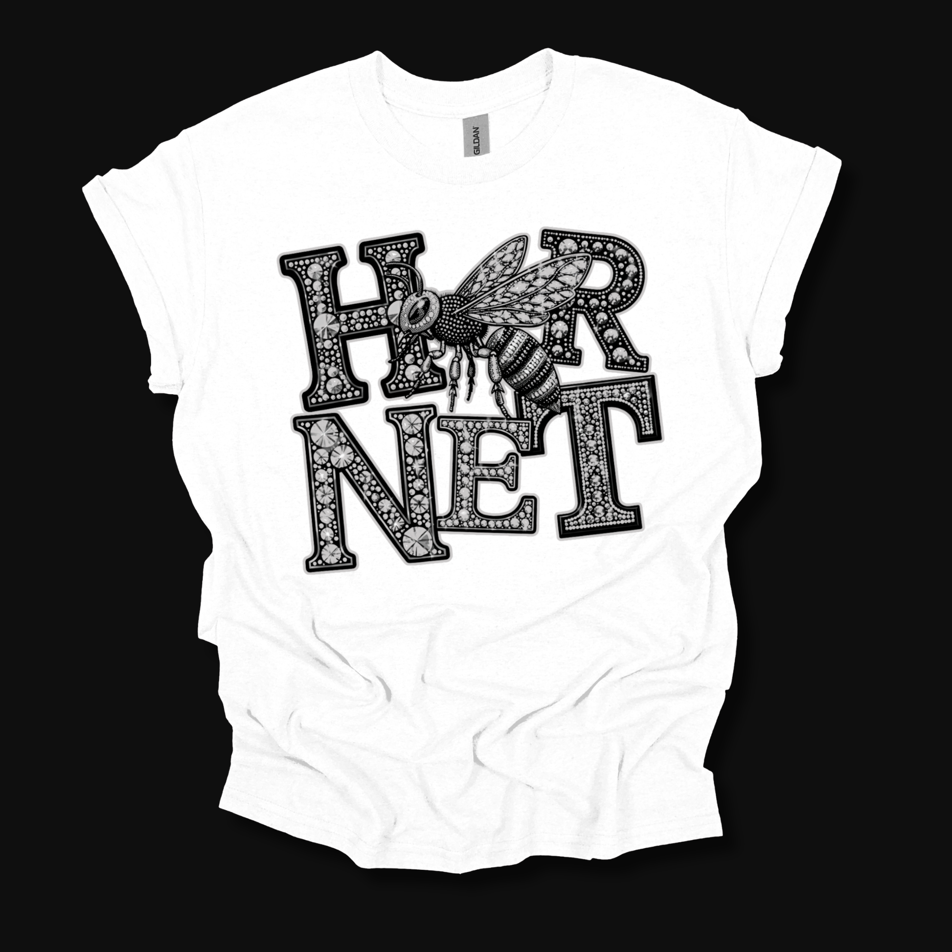 A white short-sleeve t-shirt with a black graphic print reading 'HORNET' in ornate patterned letters, featuring a detailed bee design across the chest, displayed against a solid black background.