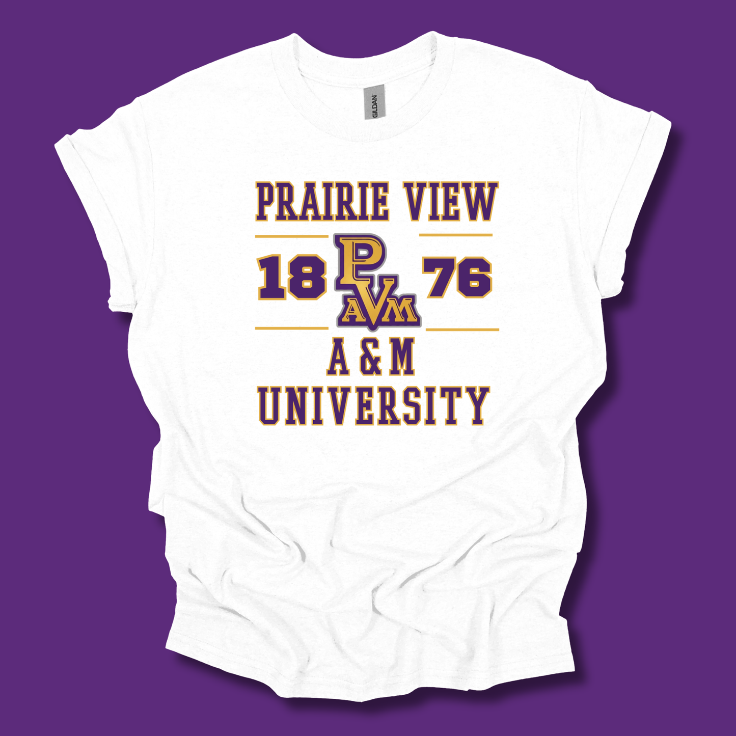 A white short-sleeve t-shirt with a vintage-style graphic print reading 'PRAIRIE VIEW 1876 A&M UNIVERSITY' and 'PAM' in the center, styled in purple and gold. The shirt is displayed flat against a solid purple background.