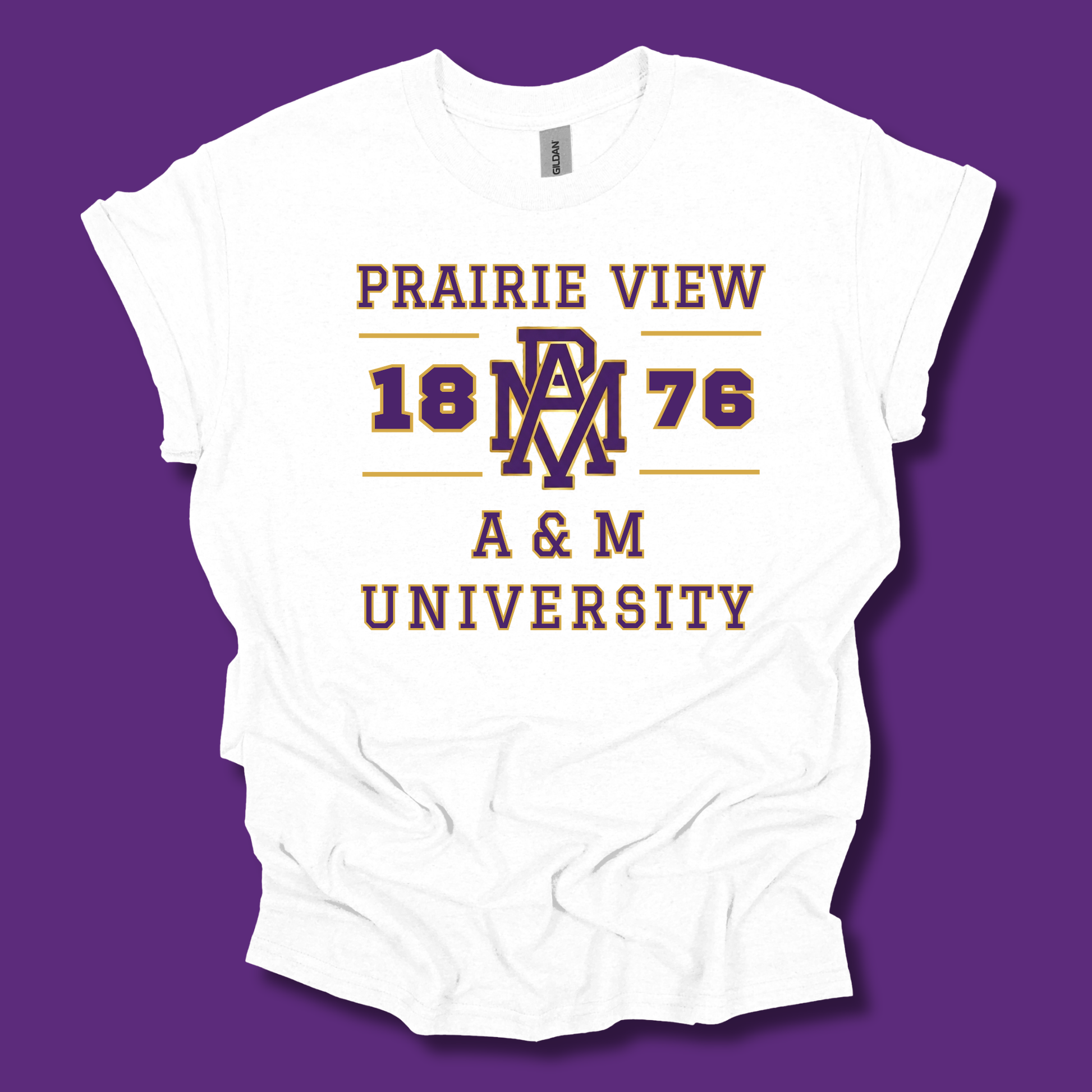 A white short-sleeve t-shirt with a vintage-style collegiate graphic reading 'PRAIRIE VIEW 1876 A & M UNIVERSITY' in maroon and gold, displayed flat against a solid purple background.