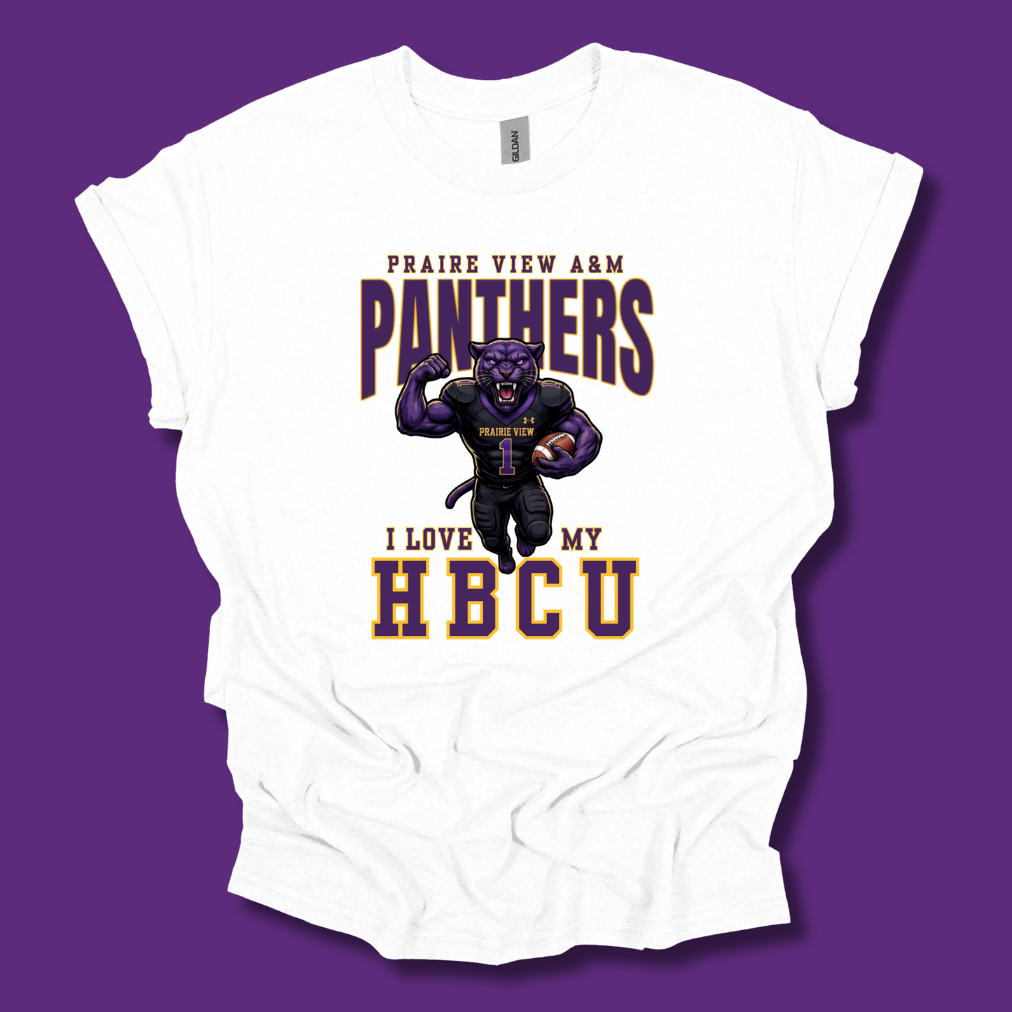 A white short-sleeve graphic T-shirt laid flat against a solid purple background. The shirt features a printed design of a purple panther football player with the text 'PRAIRE VIEW A&M PANTHERS' and 'I LOVE MY HBCU' in purple and gold lettering.