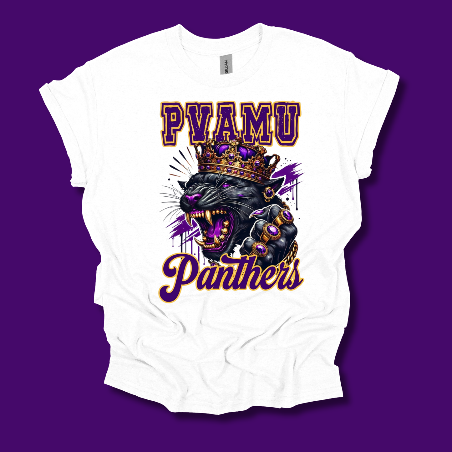 A white short-sleeve graphic t-shirt featuring a roaring black panther wearing a purple and gold crown, with the text 'PYAMU Panthers' in purple and gold. The t-shirt is displayed flat against a solid purple background.
